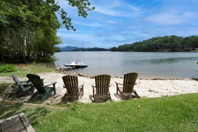 a view of a lake with outdoor seating