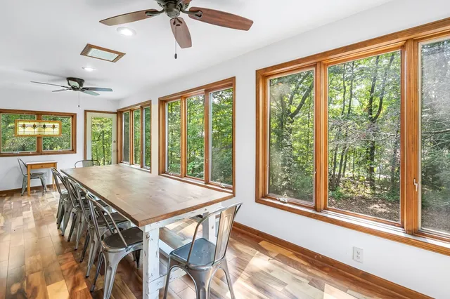 a view of a dining room with furniture window and wooden floor