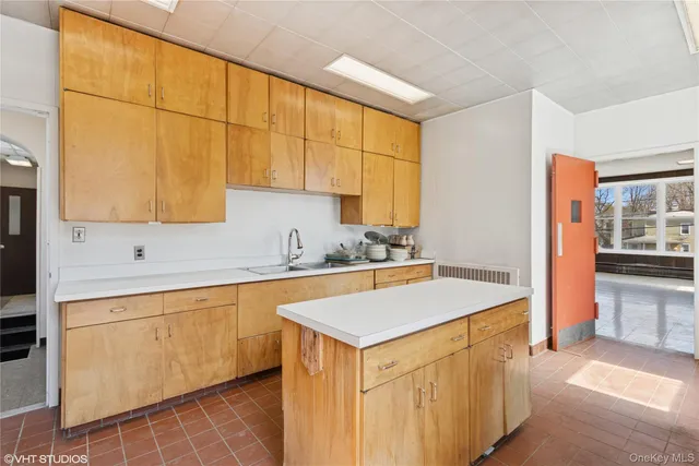 an empty room with a kitchen