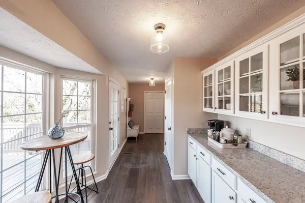 a kitchen with stainless steel appliances granite countertop hardwood floor sink stove and refrigerator