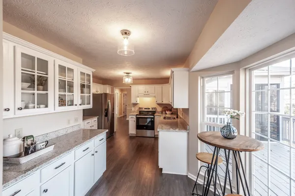 a kitchen with sink and refrigerator