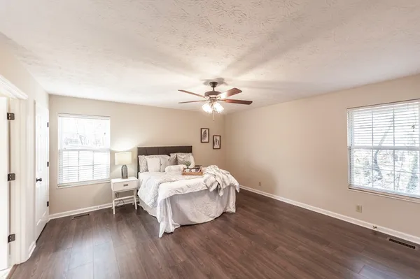 a bedroom with a bed and a window