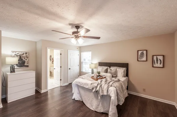 a bed room with a bed and a ceiling fan