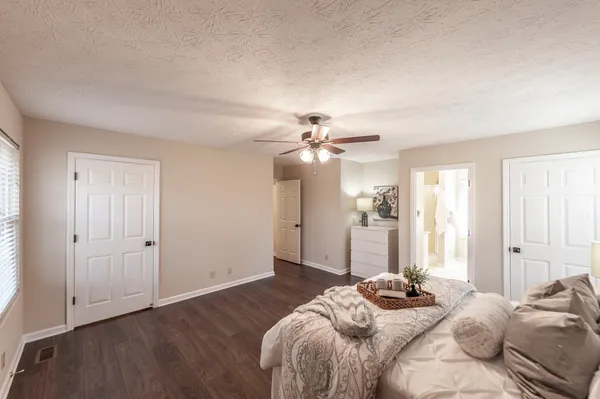 a bedroom with a bed and a chandelier