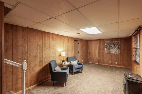 a living room with furniture a window and a flat screen tv