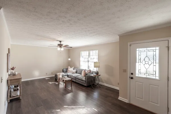 a living room with furniture and wooden floor