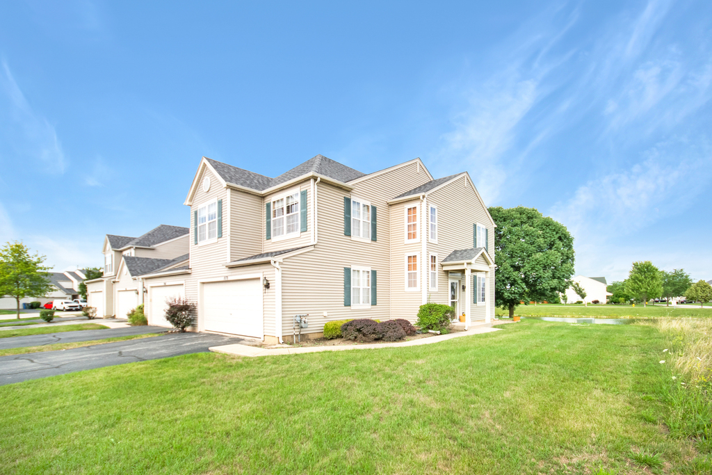 1070 Clover Drive Minooka, IL 60447 - Photo 1 of 15 a view of a white house with a big yard and plants