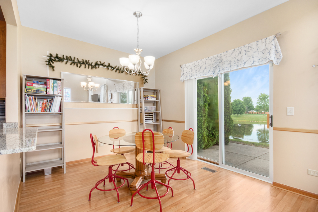 1070 Clover Drive Minooka, IL 60447 - Photo 5 of 15 a view of a dining room with furniture and wooden floor