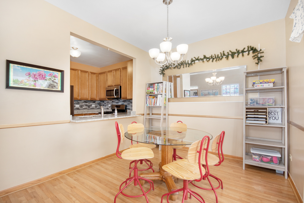 1070 Clover Drive Minooka, IL 60447 - Photo 6 of 15 a view of a dining room with furniture and wooden floor