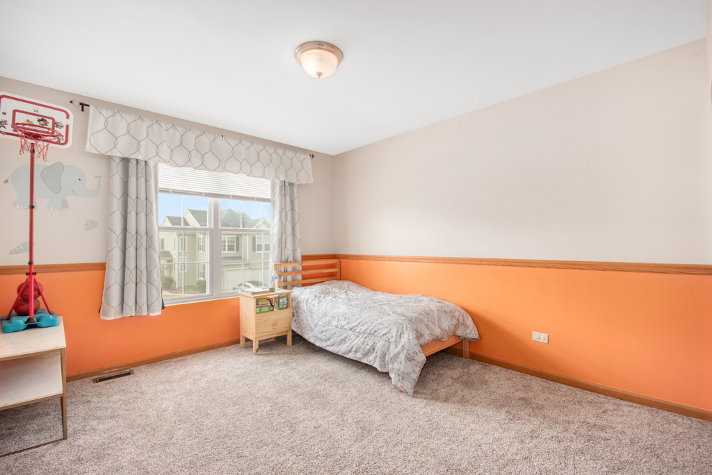 1070 Clover Drive Minooka, IL 60447 - Photo 10 of 15 a room with a bed and a window