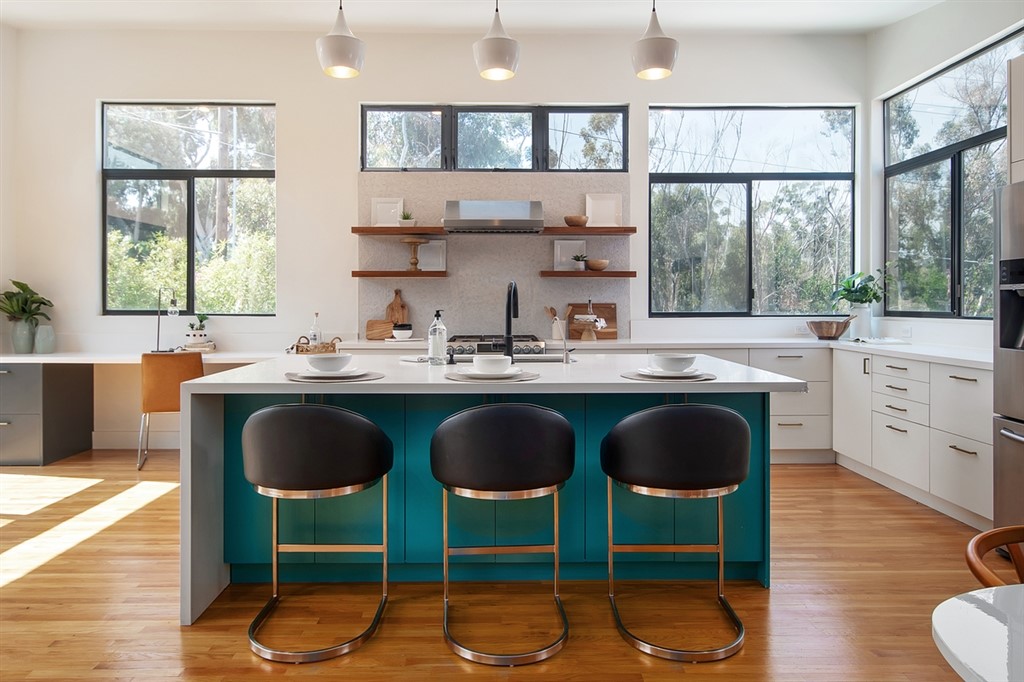 a kitchen with a dining table chairs sink and wooden floor