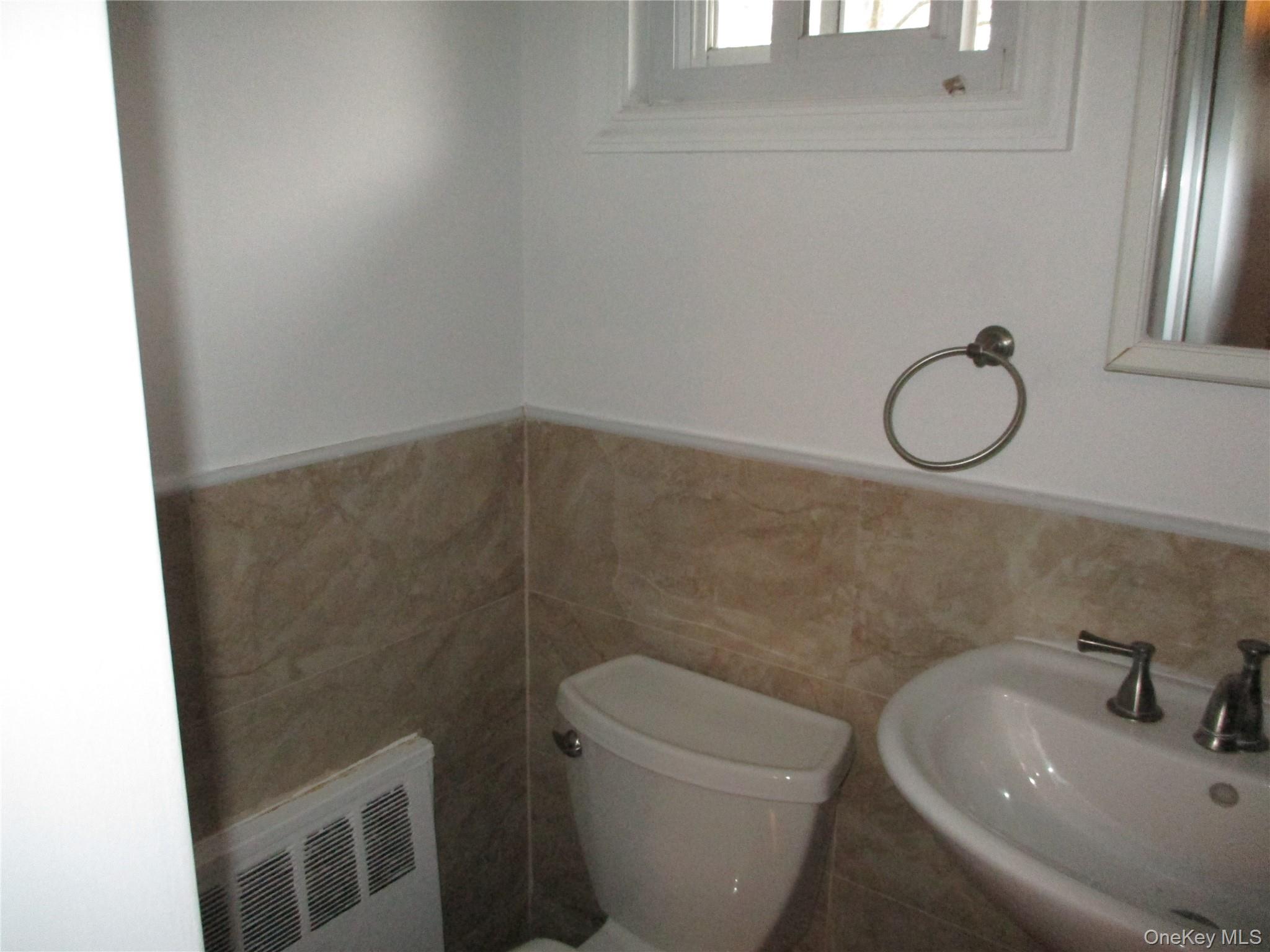 99 North Strathmore Street Valley Stream, NY 11581 - Photo 10 of 12 a bathroom with a sink and a toilet
