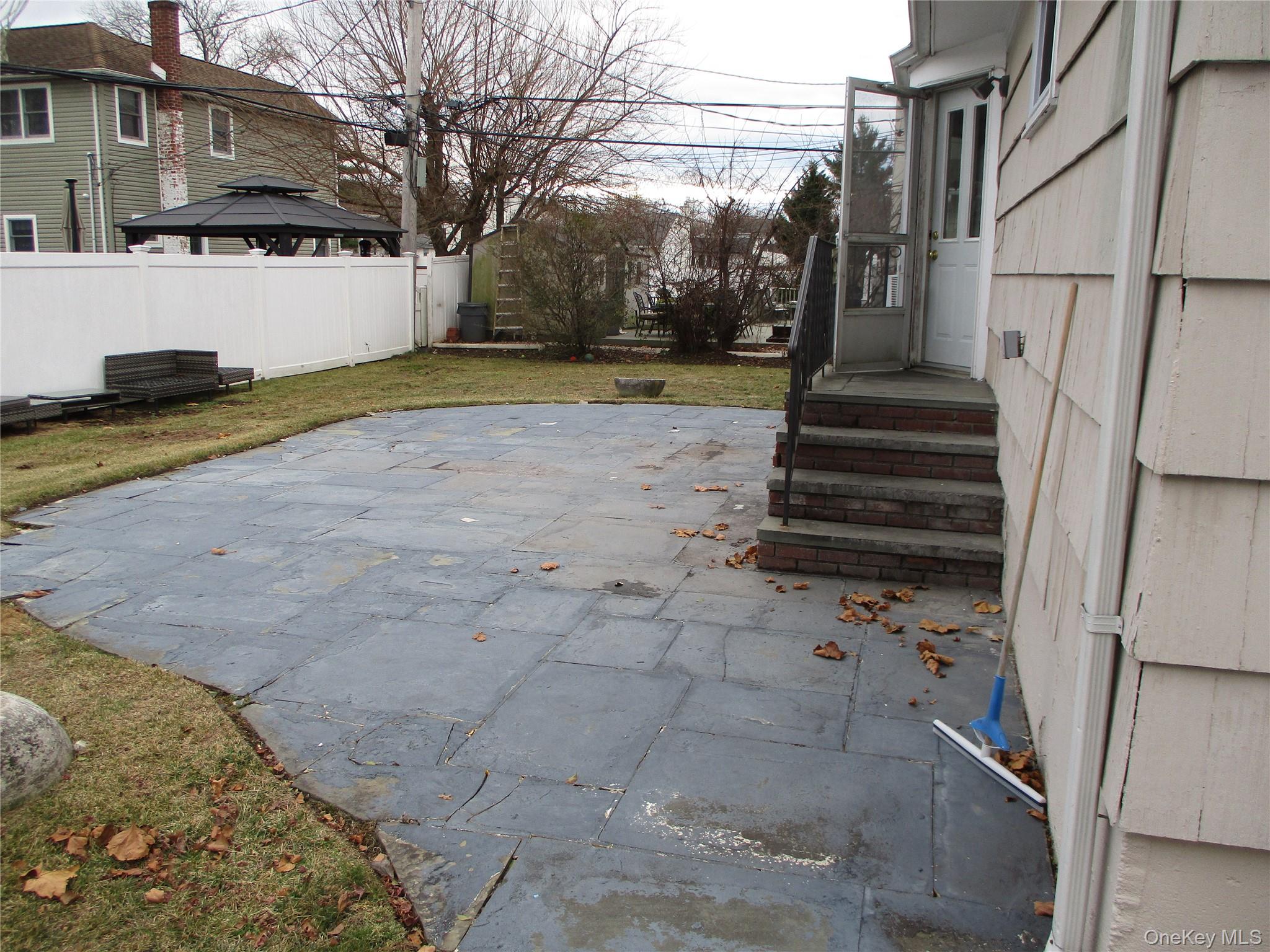 99 North Strathmore Street Valley Stream, NY 11581 - Photo 11 of 12 a view of a yard with wooden fence