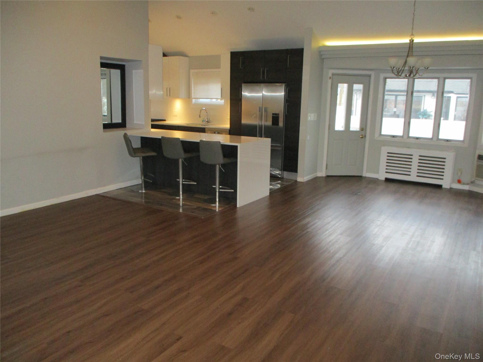 99 North Strathmore Street Valley Stream, NY 11581 - Photo 12 of 12 an empty room with wooden floor and windows