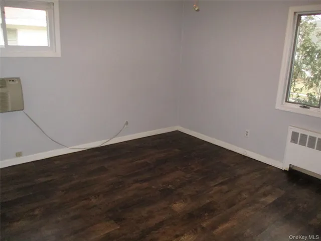 a view of a small space with wooden floor and a window