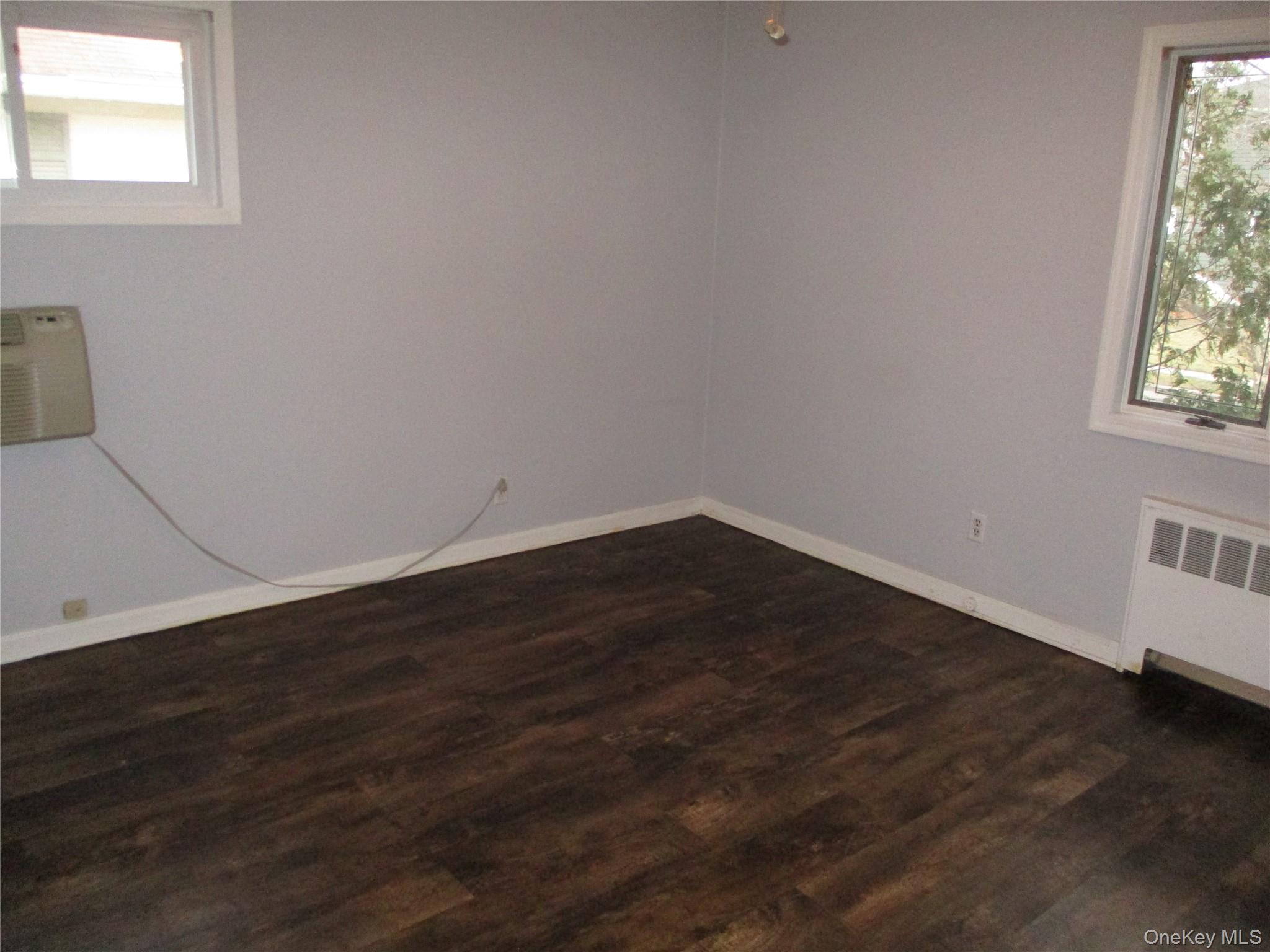 99 North Strathmore Street Valley Stream, NY 11581 - Photo 9 of 12 a view of a small space with wooden floor and a window