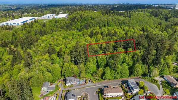 an aerial view of a houses with a yard