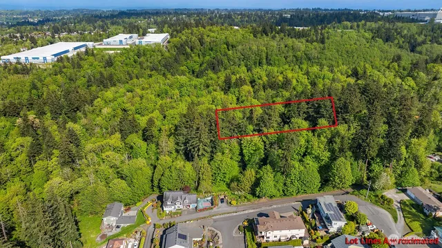 an aerial view of a houses with a yard