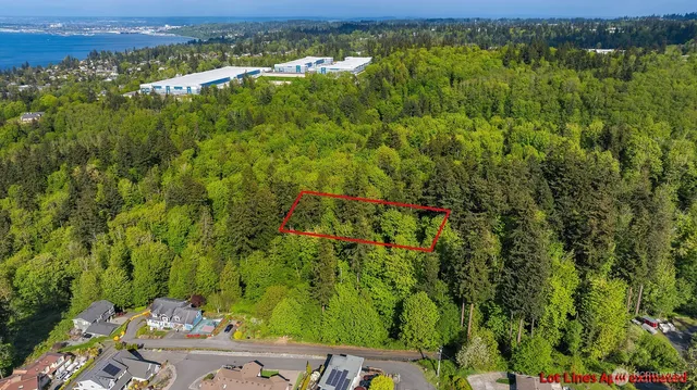 an aerial view of residential houses with outdoor space and trees