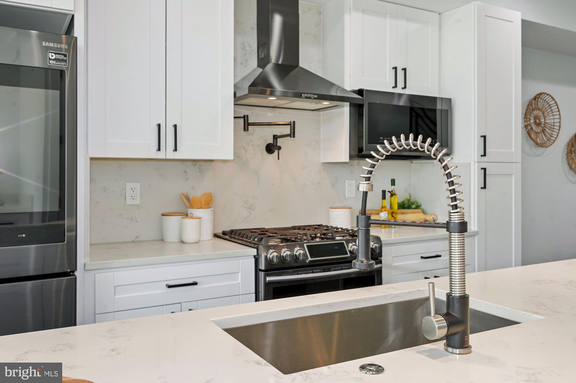 418 21st Street Northeast Washington, DC 20002 - Photo 9 of 48 a kitchen with stainless steel appliances a stove a sink and cabinets