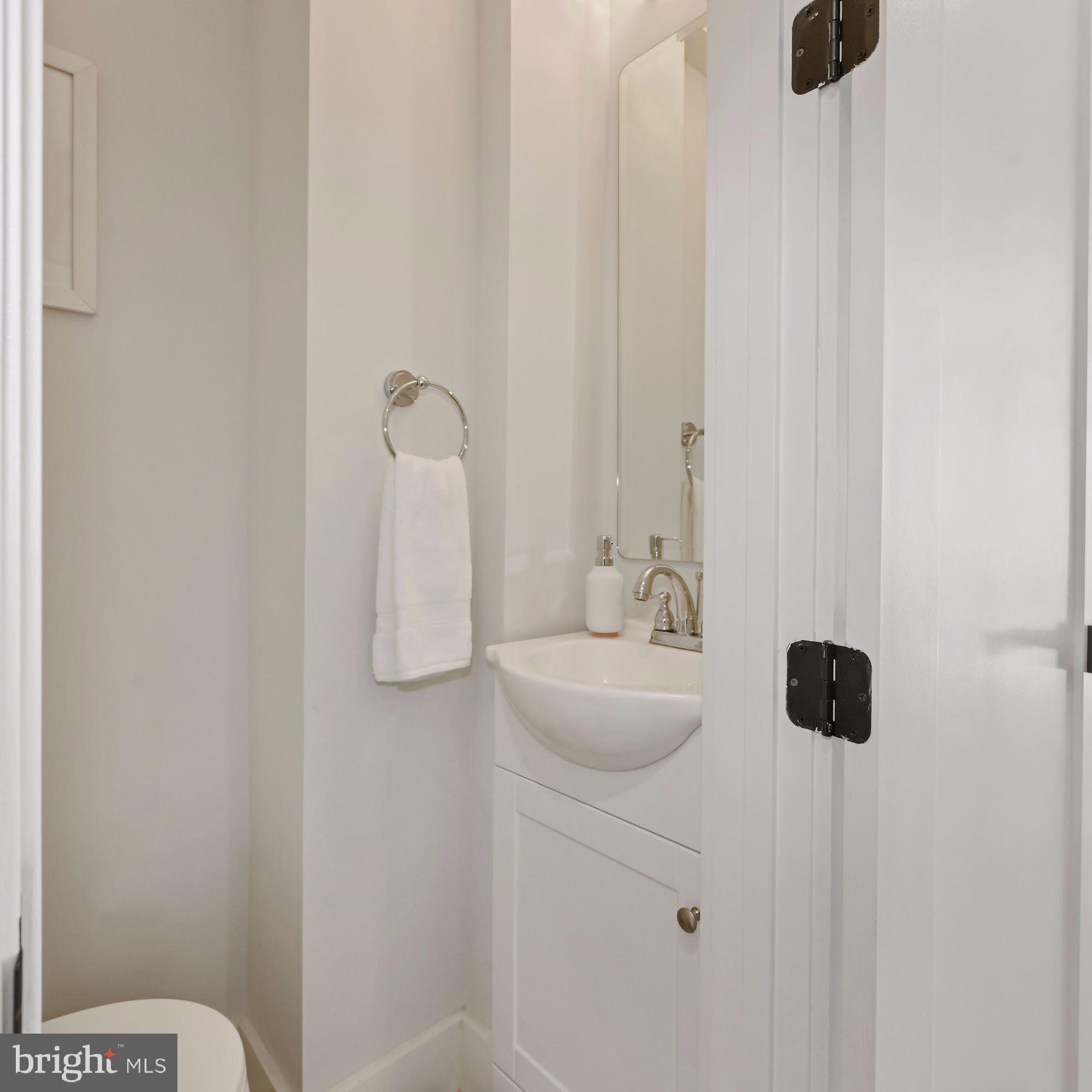 418 21st Street Northeast Washington, DC 20002 - Photo 14 of 48 a bathroom with a sink a toilet and mirror