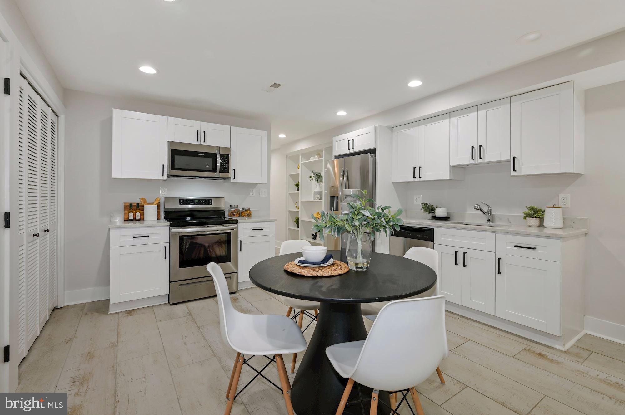 418 21st Street Northeast Washington, DC 20002 - Photo 31 of 48 a kitchen with stainless steel appliances a dining table and chairs in it