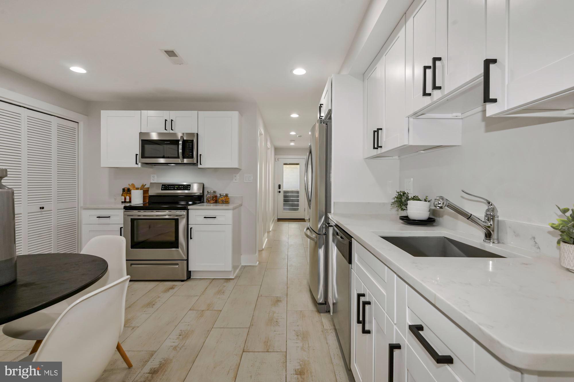 418 21st Street Northeast Washington, DC 20002 - Photo 32 of 48 a kitchen with stainless steel appliances a sink stove and refrigerator