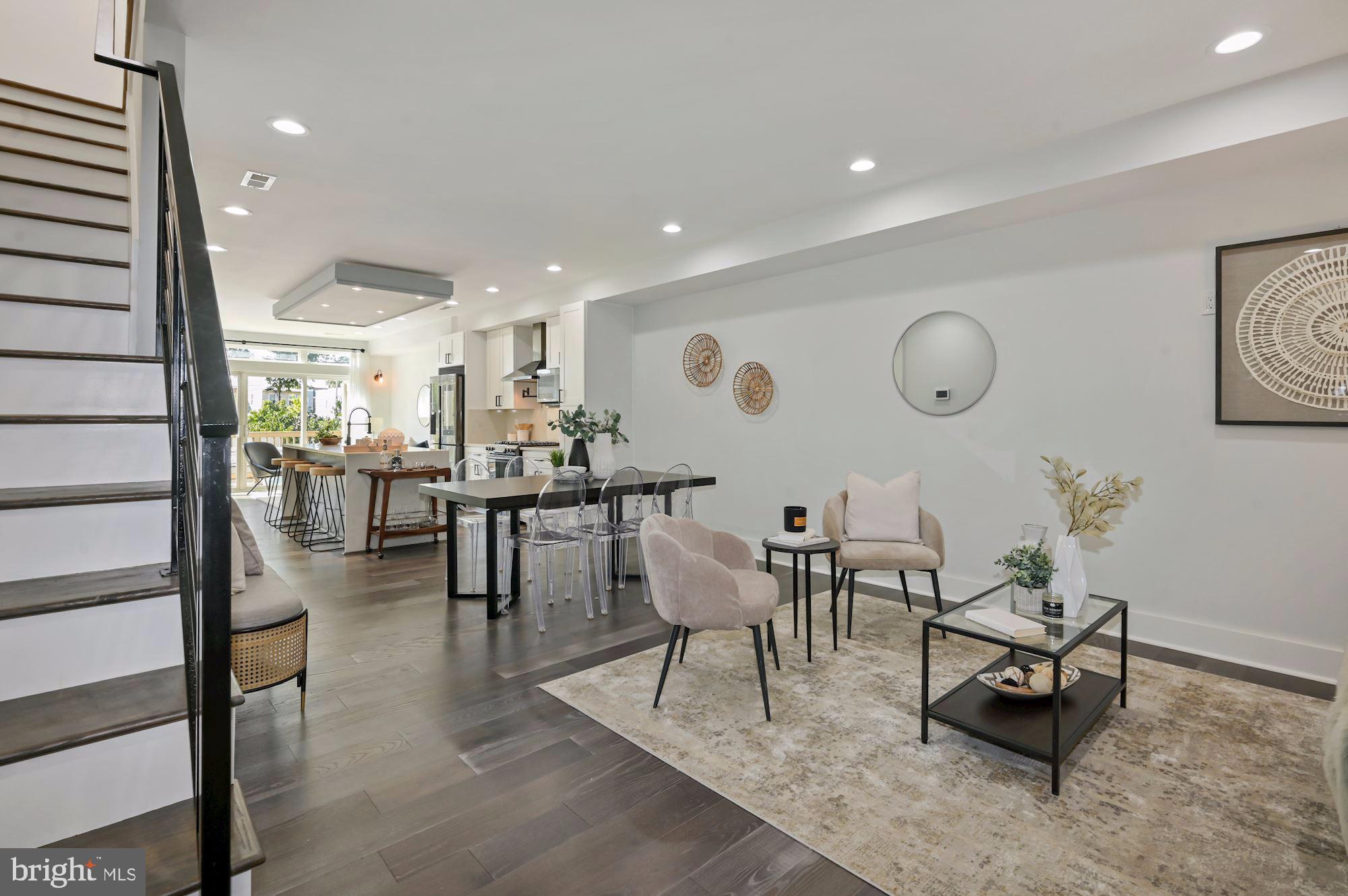 418 21st Street Northeast Washington, DC 20002 - Photo 47 of 48 a living room with couches a dining table and kitchen view with wooden floor