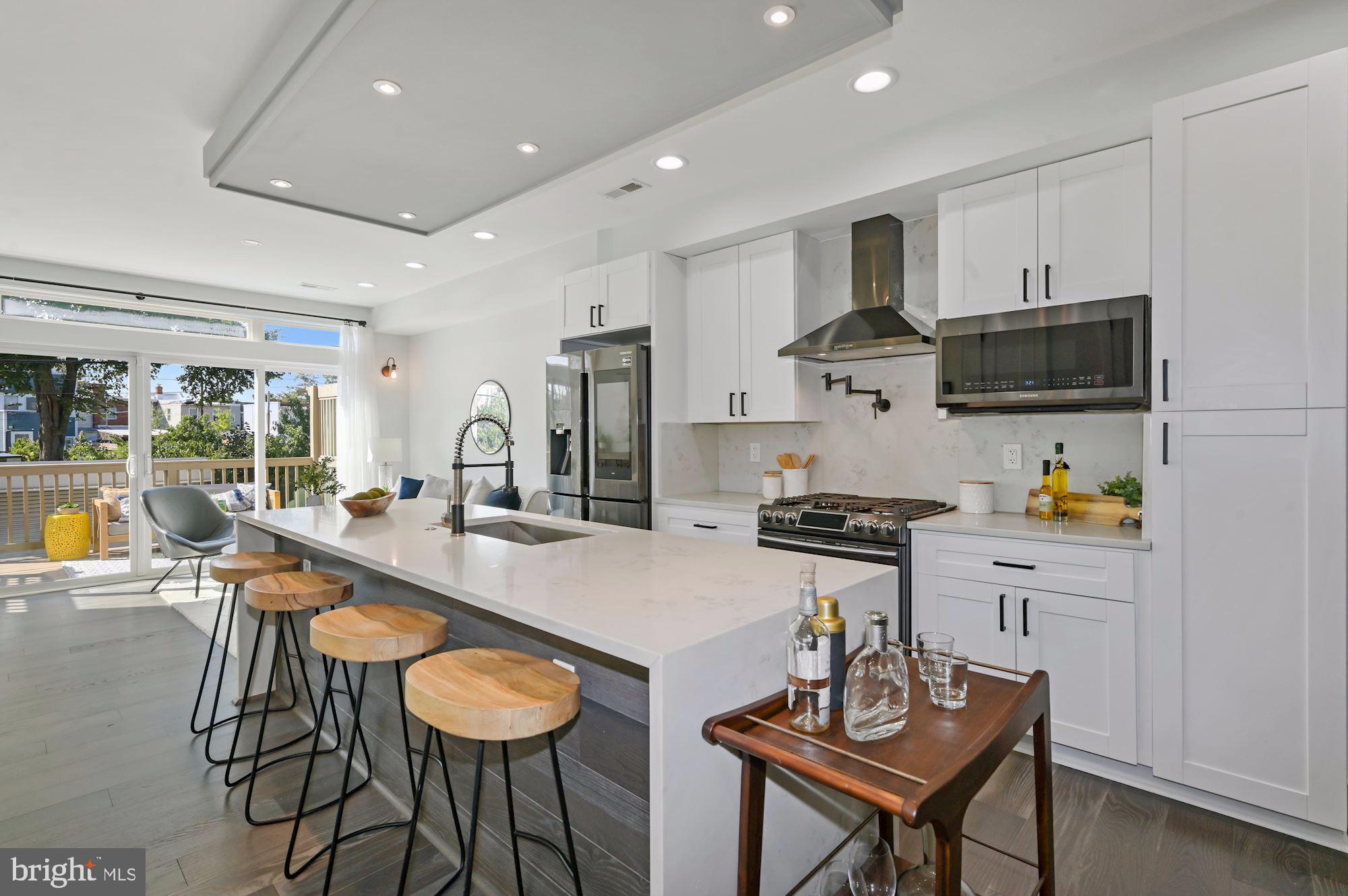 418 21st Street Northeast Washington, DC 20002 - Photo 8 of 48 a kitchen with stainless steel appliances granite countertop a stove a sink and a refrigerator