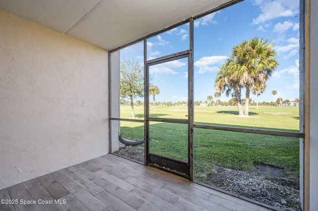 a view of a room with yard from balcony