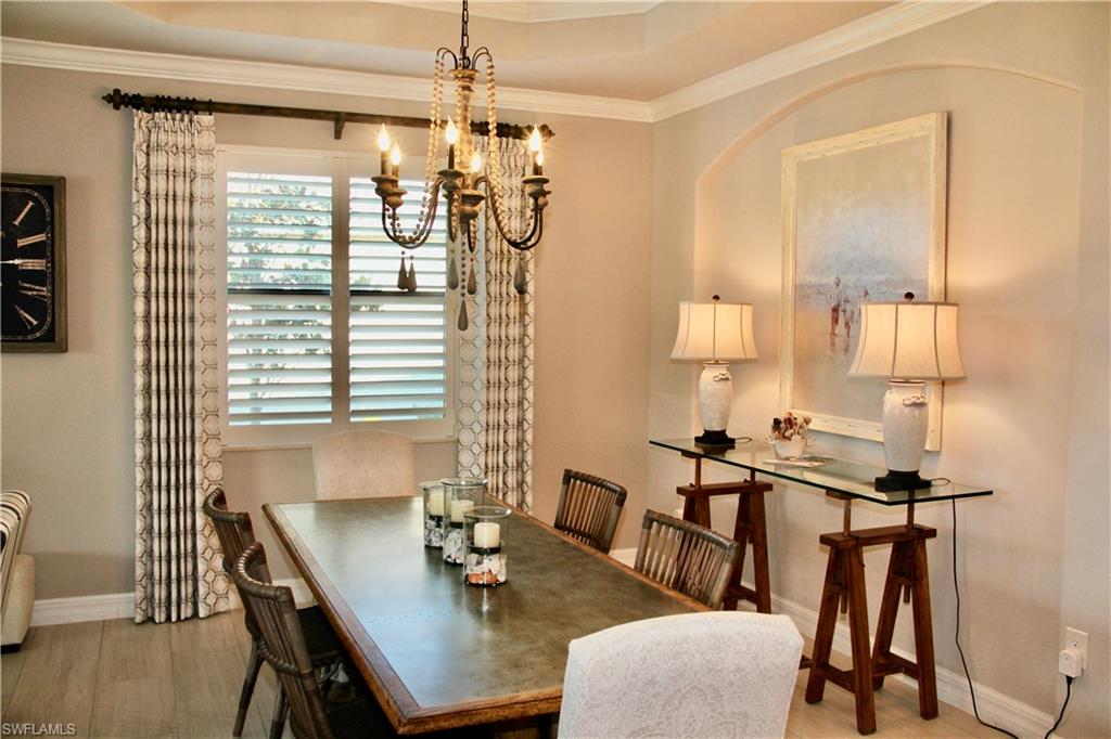 9449 Rialto Drive Naples, FL 34113 - Photo 11 of 44 a view of a dining room with furniture and wooden floor