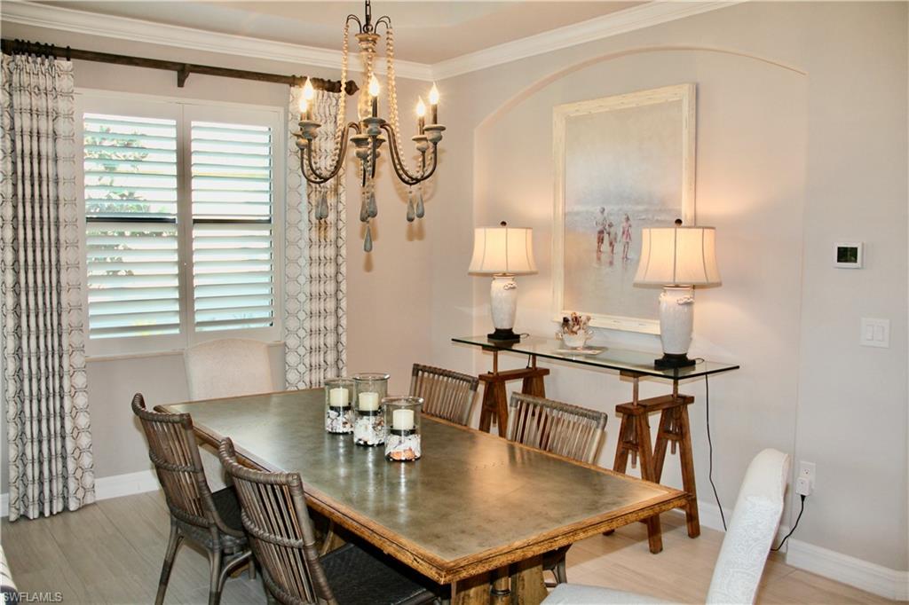 9449 Rialto Drive Naples, FL 34113 - Photo 12 of 44 a view of a dining room with furniture and wooden floor
