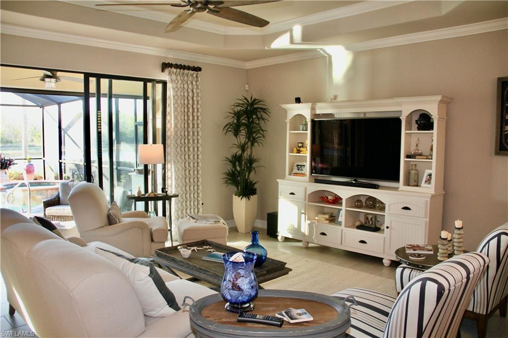 9449 Rialto Drive Naples, FL 34113 - Photo 13 of 44 a living room with furniture and a flat screen tv