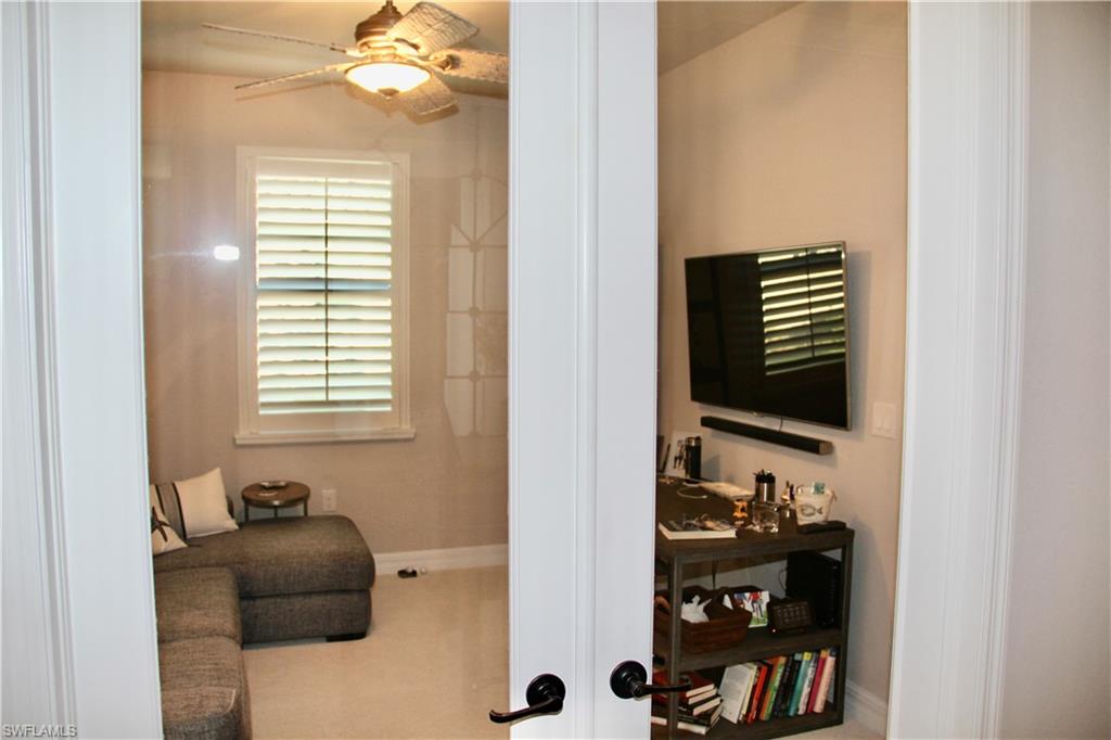 9449 Rialto Drive Naples, FL 34113 - Photo 15 of 44 a room with a walk in closet and a window