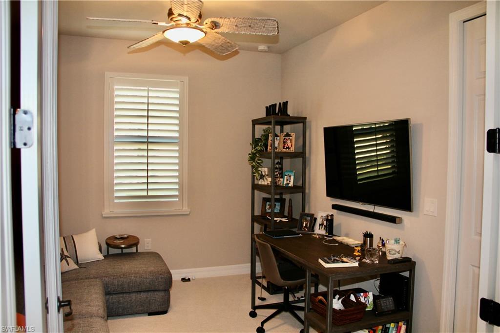 9449 Rialto Drive Naples, FL 34113 - Photo 16 of 44 a bedroom with furniture and a window