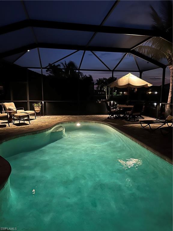 9449 Rialto Drive Naples, FL 34113 - Photo 20 of 44 a view of a yard with table and chairs under an umbrella