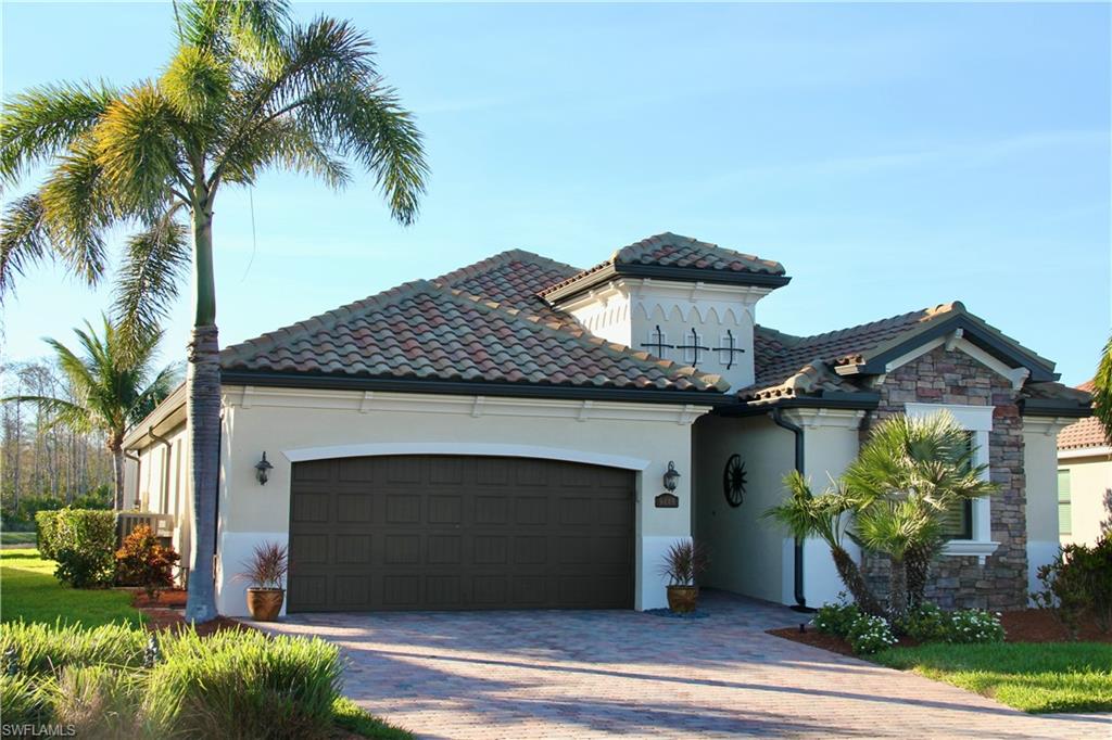 9449 Rialto Drive Naples, FL 34113 - Photo 2 of 44 a front view of a house with a garden