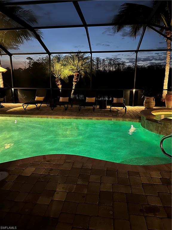 9449 Rialto Drive Naples, FL 34113 - Photo 22 of 44 a view of a backyard with table and chairs under an umbrella