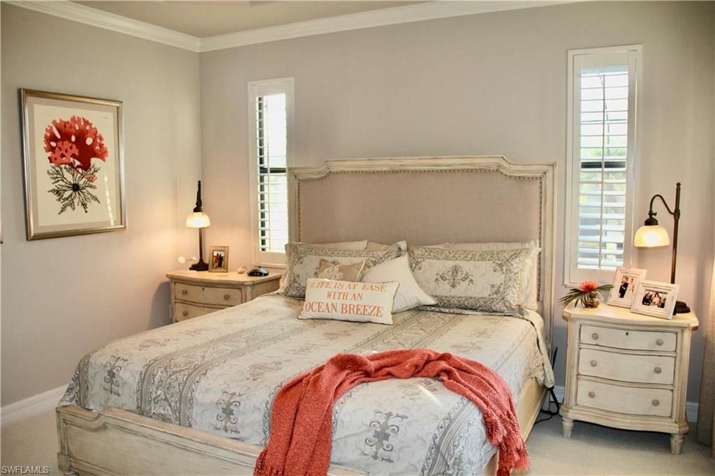 9449 Rialto Drive Naples, FL 34113 - Photo 27 of 44 a bedroom with a bed and a painting on the wall