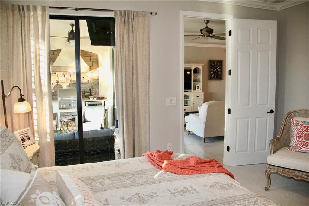 9449 Rialto Drive Naples, FL 34113 - Photo 28 of 44 a bedroom with a bed and a mirror