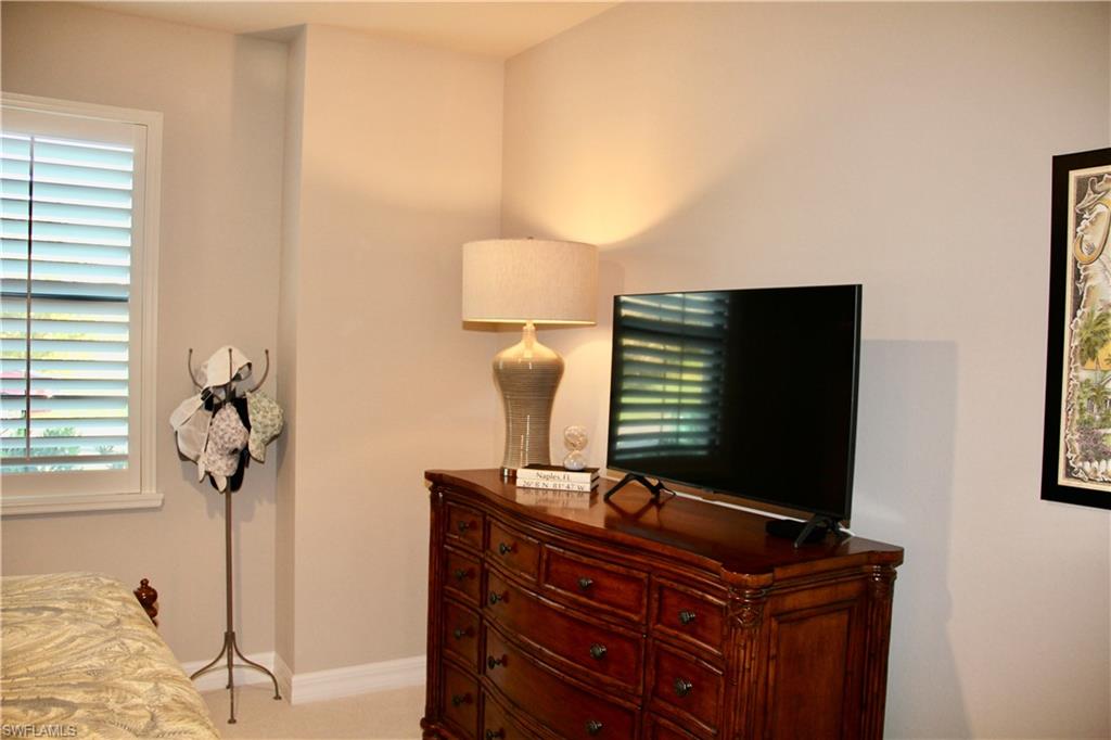 9449 Rialto Drive Naples, FL 34113 - Photo 37 of 44 a living room with furniture and flat screen tv