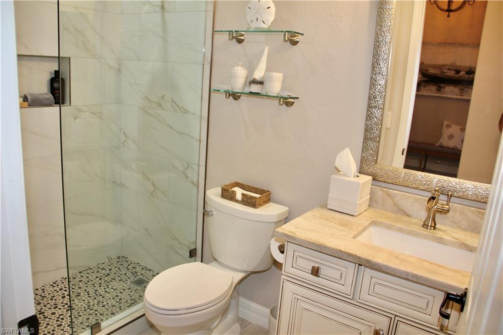 9449 Rialto Drive Naples, FL 34113 - Photo 39 of 44 a bathroom with a sink a toilet and shower