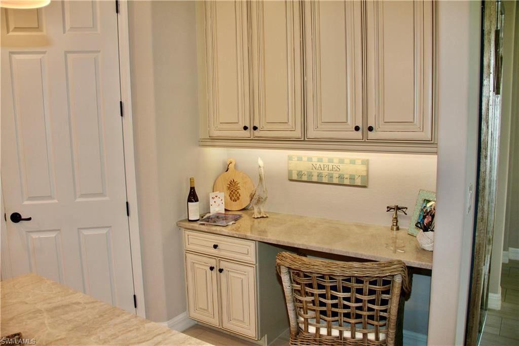 9449 Rialto Drive Naples, FL 34113 - Photo 10 of 44 a room with granite countertop a sink and a stove