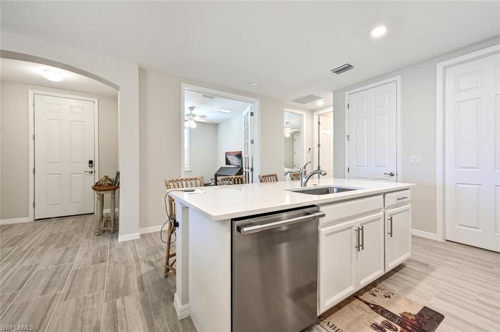 14680 Edgewater Circle Naples, FL 34114 - Photo 14 of 21 a kitchen with a sink and cabinets