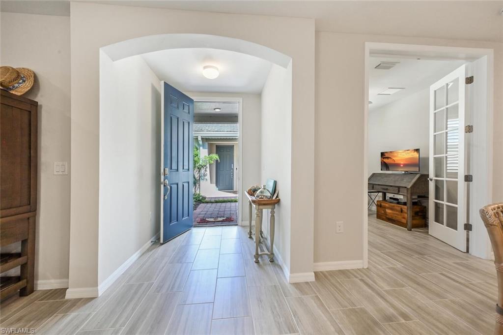 14680 Edgewater Circle Naples, FL 34114 - Photo 15 of 21 view of livingroom with furniture and wooden floor