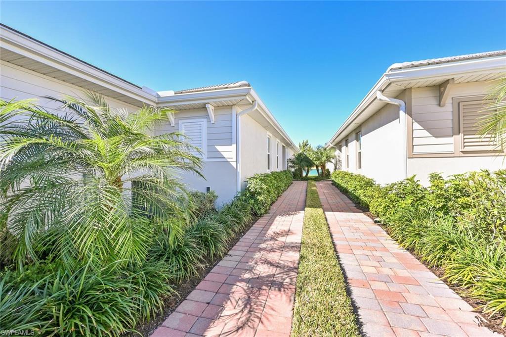 14680 Edgewater Circle Naples, FL 34114 - Photo 2 of 21 a view of a back yard with flower plants