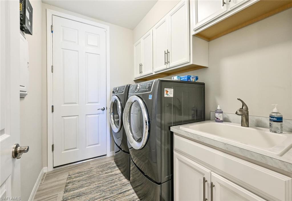 14680 Edgewater Circle Naples, FL 34114 - Photo 21 of 21 a utility room with dryer and washer