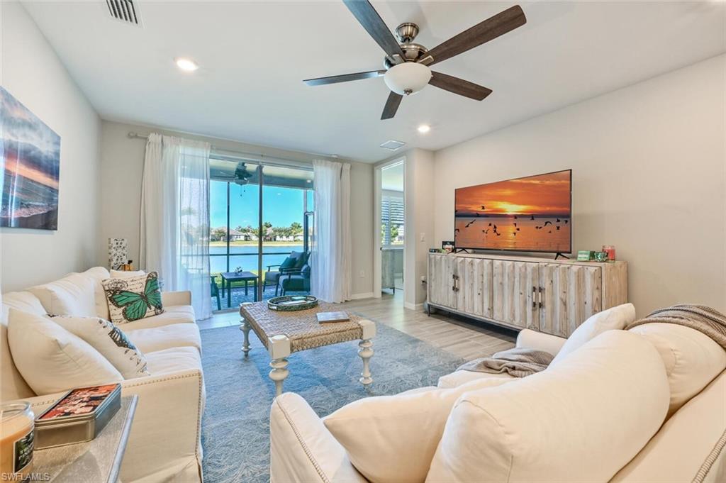 14680 Edgewater Circle Naples, FL 34114 - Photo 6 of 21 a living room with furniture and a flat screen tv