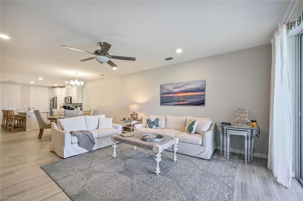 14680 Edgewater Circle Naples, FL 34114 - Photo 7 of 21 a living room with furniture and a ceiling fan