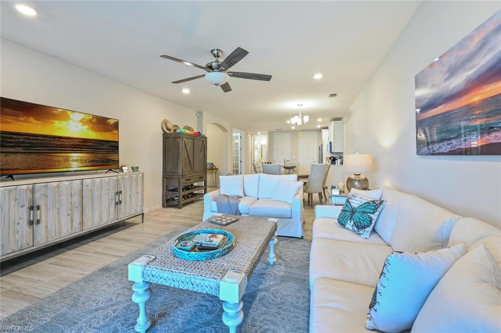 14680 Edgewater Circle Naples, FL 34114 - Photo 8 of 21 a living room with furniture and a flat screen tv